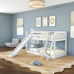 Kids' white wooden bunk bed with slide and ladder in light blue bedroom, striped bedding, cozy rug and framed wall art