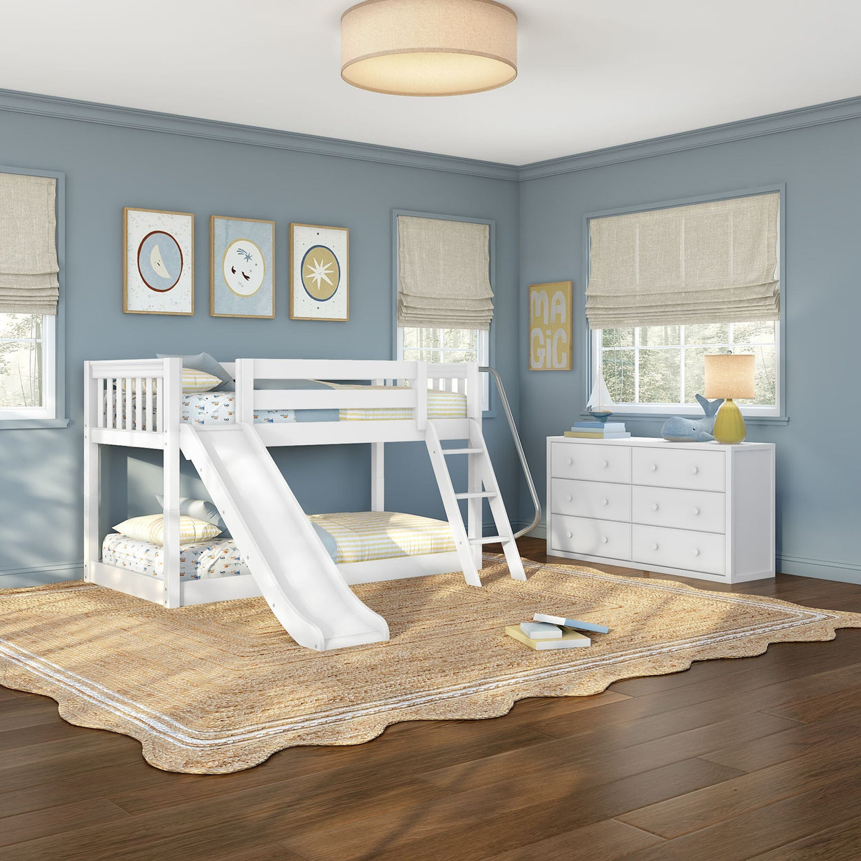 Children's bedroom with white twin bunk bed and slide, blue walls, white dresser, woven rug and playful wall art