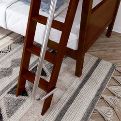 Wooden bunk bed ladder with safety handle next to a cozy rug in a bedroom setting.