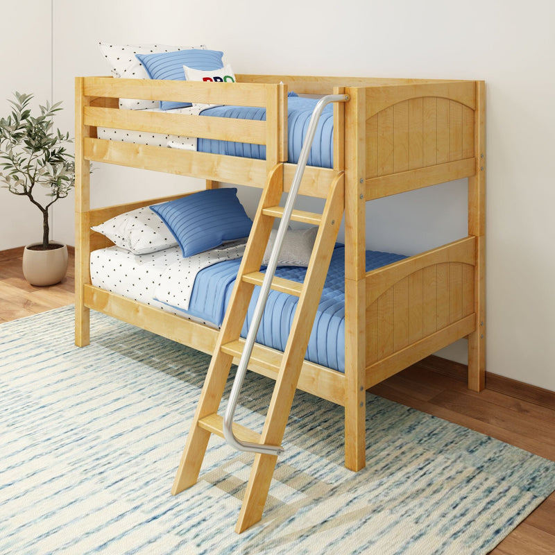 Light wood twin-over-twin bunk bed with ladder, blue quilted bedding and star-pattern sheets in a modern kids' bedroom with rug
