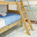 Wooden bunk bed ladder with blue quilted bedding in a modern kids' bedroom