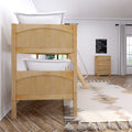 Wooden bunk bed with white bedding in a bright neutral kids' bedroom featuring a natural wood dresser, ladder, tassel rug and travel sign wall art
