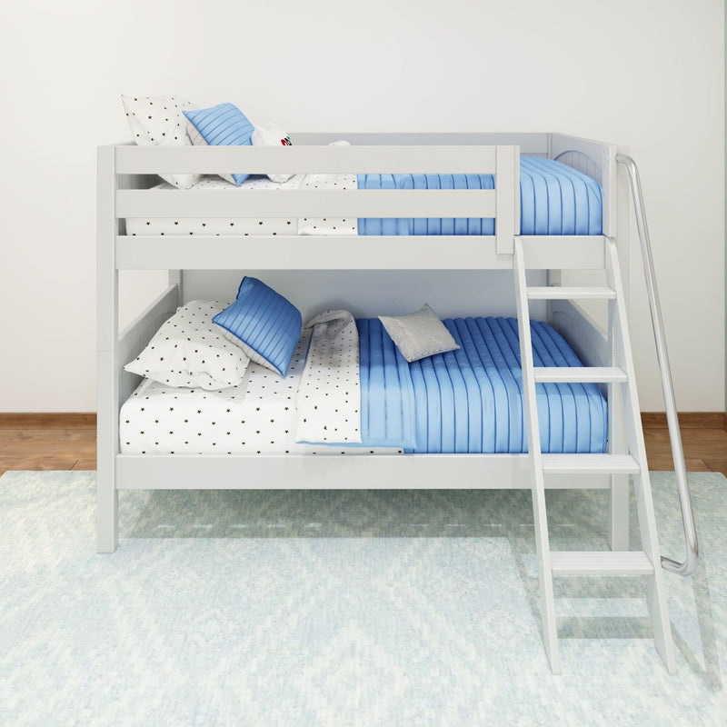 White wooden twin-over-twin bunk bed with blue quilted bedding, star-print sheets and ladder in a modern kids' bedroom