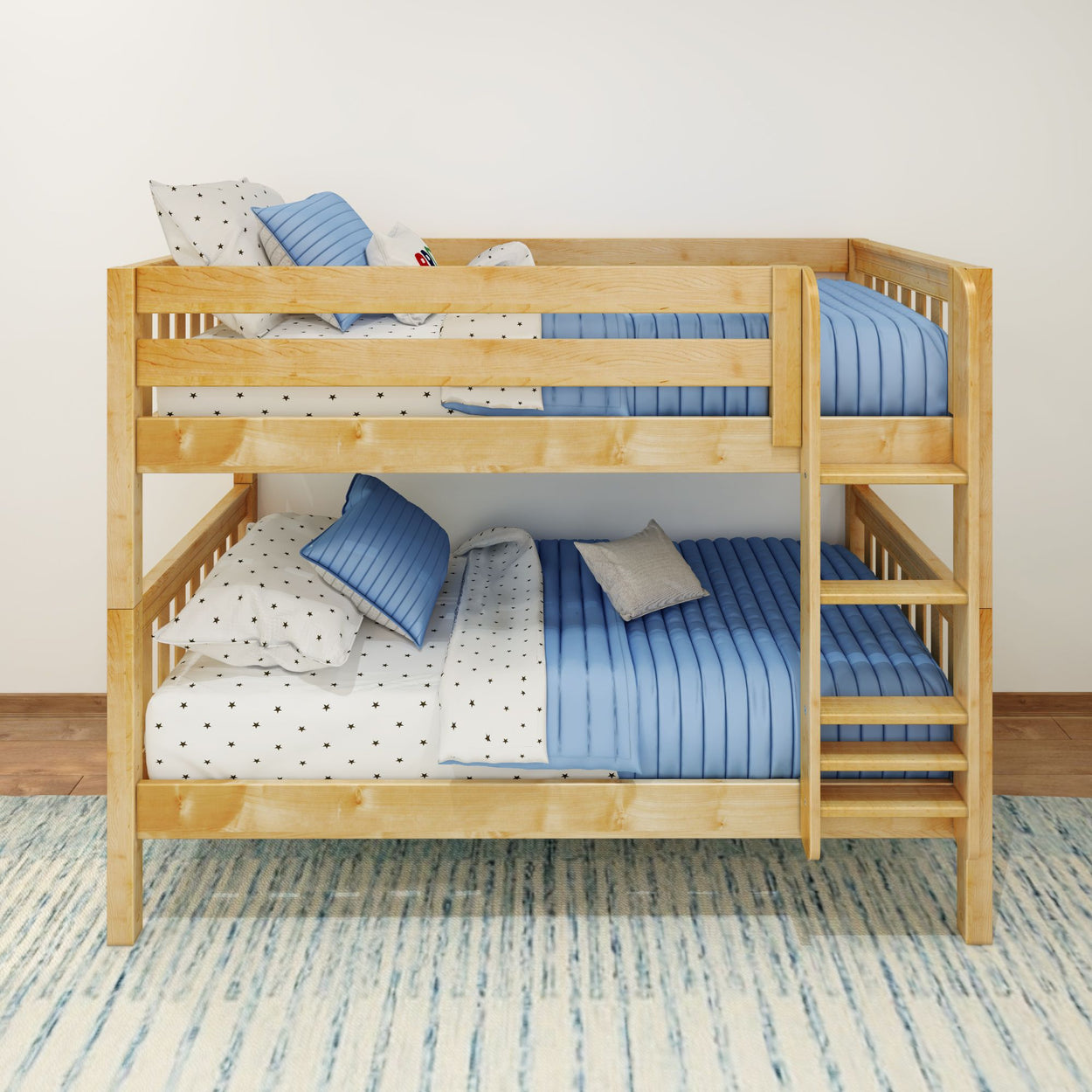 Solid wood twin-over-twin bunk bed with blue quilted bedding, star-print sheets and built-in ladder for kids' bedroom.