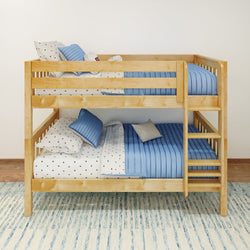 Solid wood twin-over-twin bunk bed with blue quilted bedding, star-print sheets and built-in ladder for kids' bedroom.