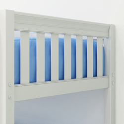 Close-up of white wooden baby crib railing with blue mattress and visible screws, nursery safety detail