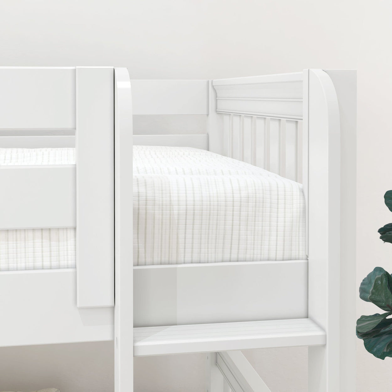 Close-up of white wooden bunk bed ladder and guardrail with mattress covered in white striped bedding in a modern nursery room