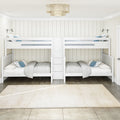 White twin-over-twin bunk beds in a bright coastal kids' bedroom with shiplap walls, blue pillows, beige rug, and woven pendant light