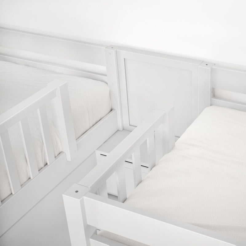 Close-up of white wooden toddler bed guardrail and mattress, modern nursery safety bed rails