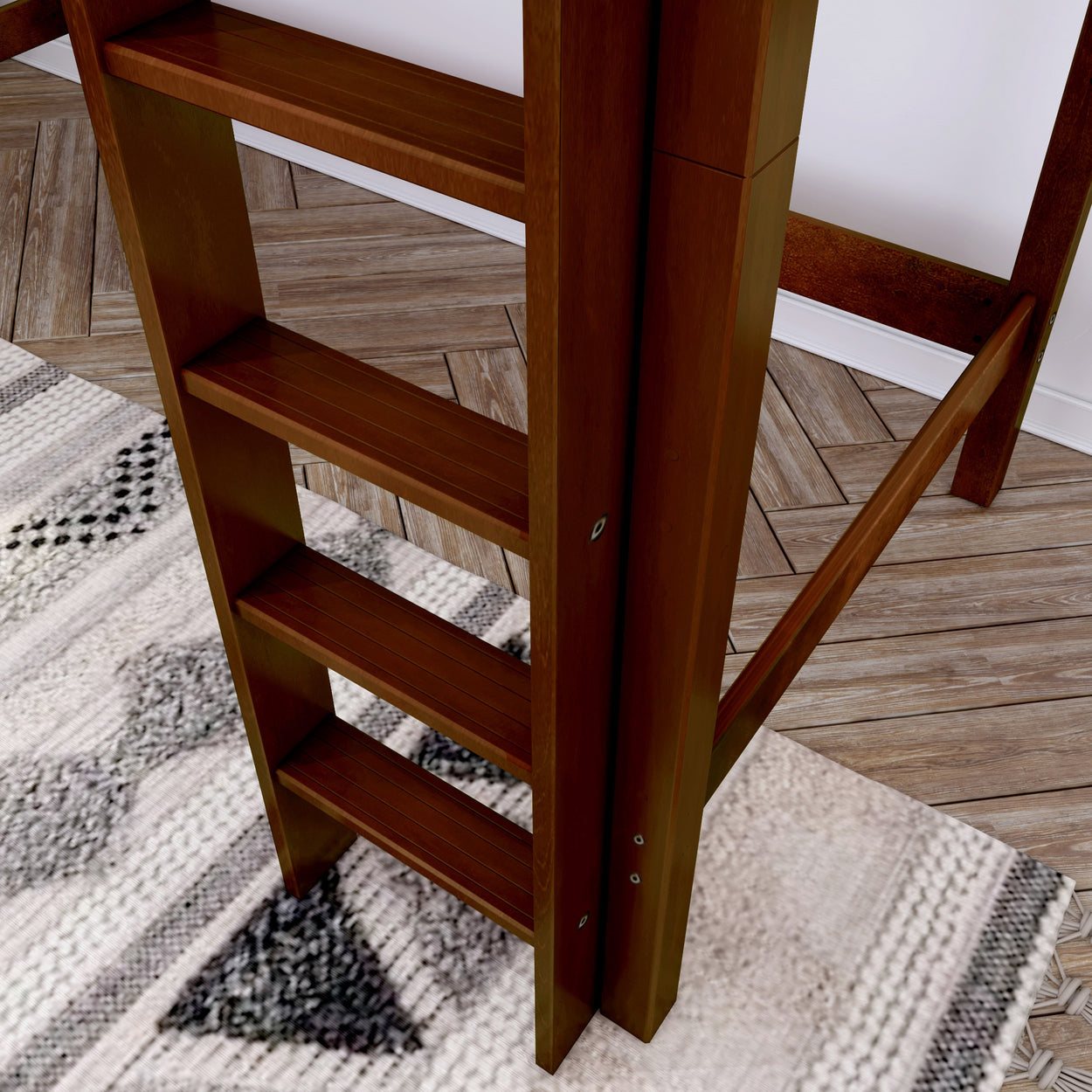 Wooden staircase ladder on herringbone floor with patterned rug, ideal for modern loft design.