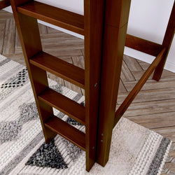 Wooden staircase ladder on herringbone floor with patterned rug, ideal for modern loft design.