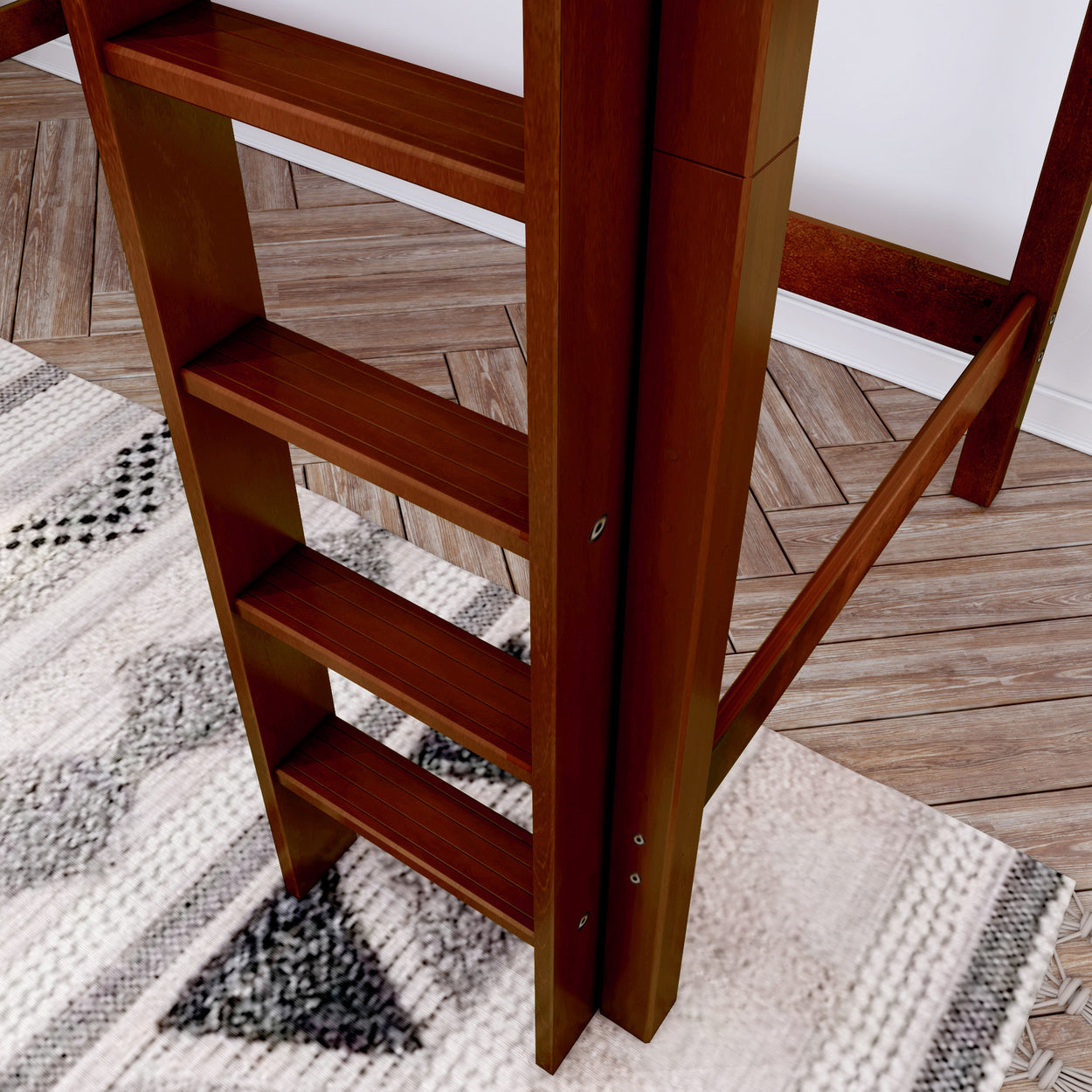 Wooden loft bed ladder on herringbone floor with geometric rug design.