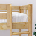 Close-up of natural maple solid wood bunk bed frame with vertical slats, safety rail and ladder, showing white striped mattress in a modern children's bedroom