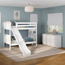 White wooden bunk bed with slide in blue kids' bedroom featuring a striped area rug, white dresser, Roman shades and hot air balloon wall art