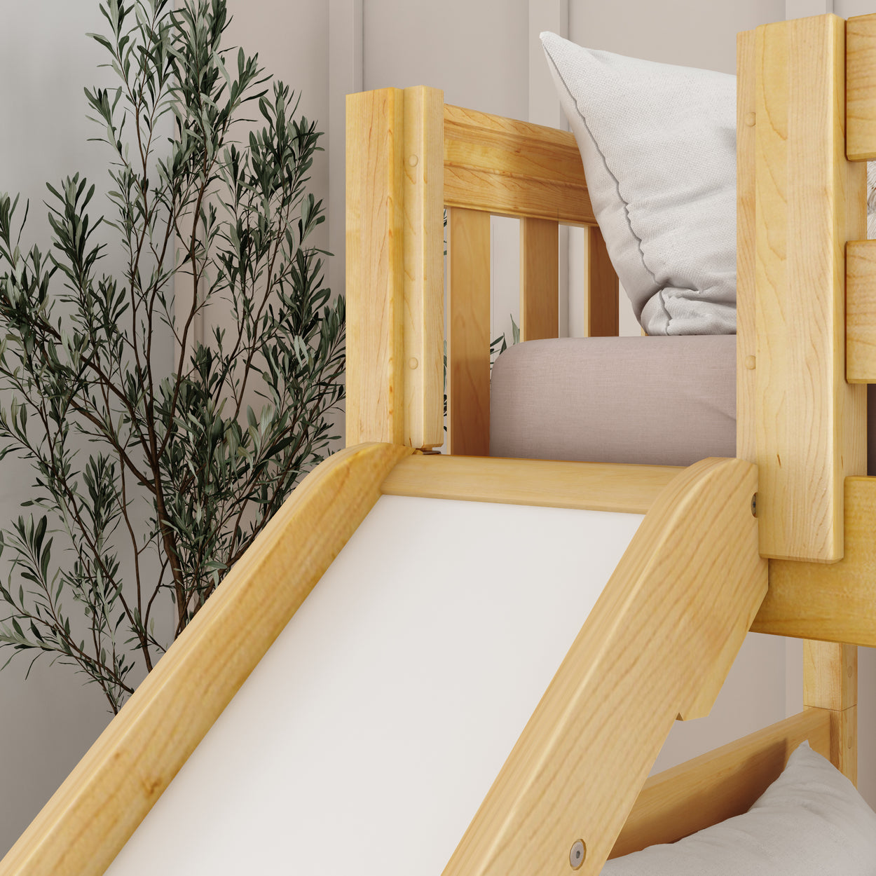 Wooden loft bed with slide and pillow, next to an olive tree plant in a modern bedroom setting.