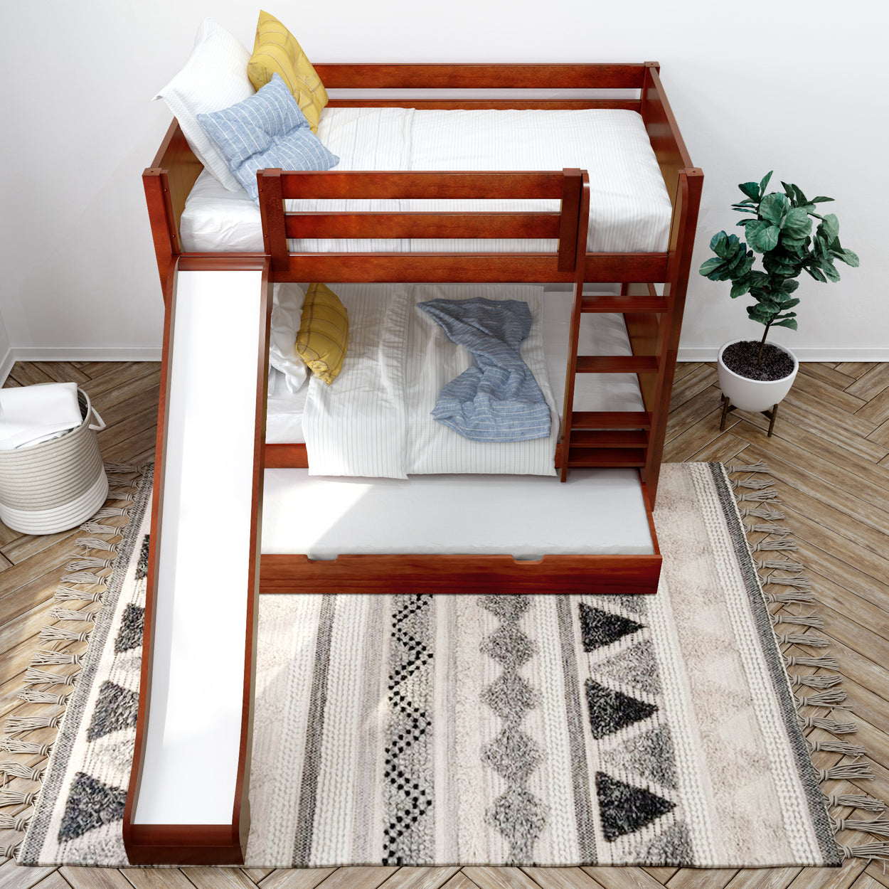 Wooden bunk bed with slide and storage drawer in modern bedroom featuring potted plant and patterned rug.