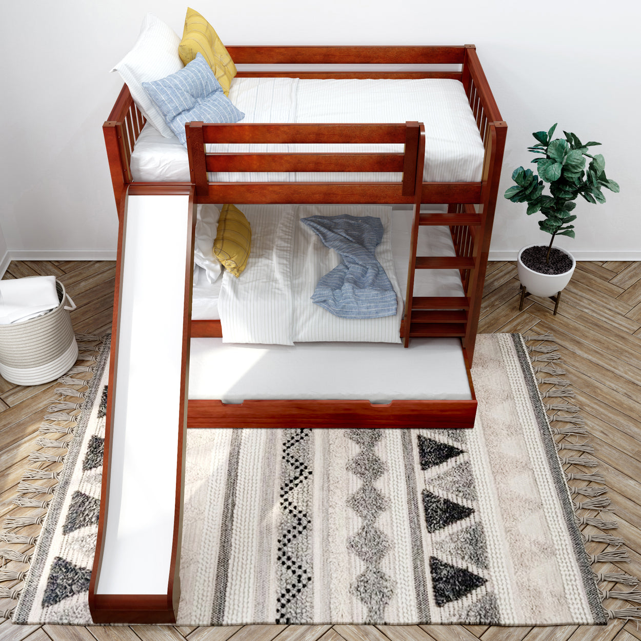 Kids' wooden bunk bed with slide and staircase in modern bedroom with geometric rug and potted plant.