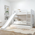 White wooden children's bunk bed with slide, trundle drawer and ladder in bright minimalist bedroom with neutral bedding, built-in wall shelves and patterned area rug
