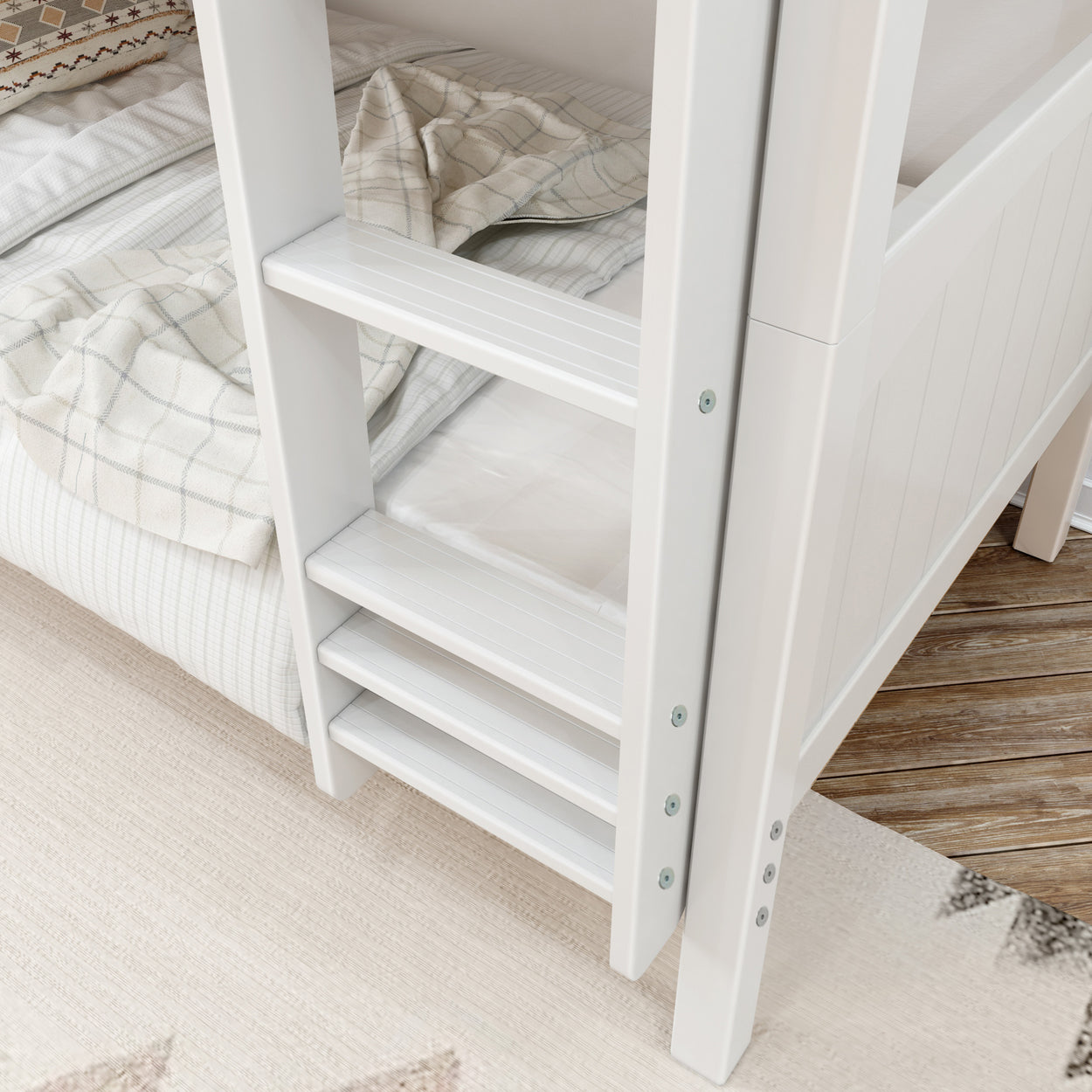 White wooden bunk bed ladder with plaid bedding on a cozy bedroom rug.