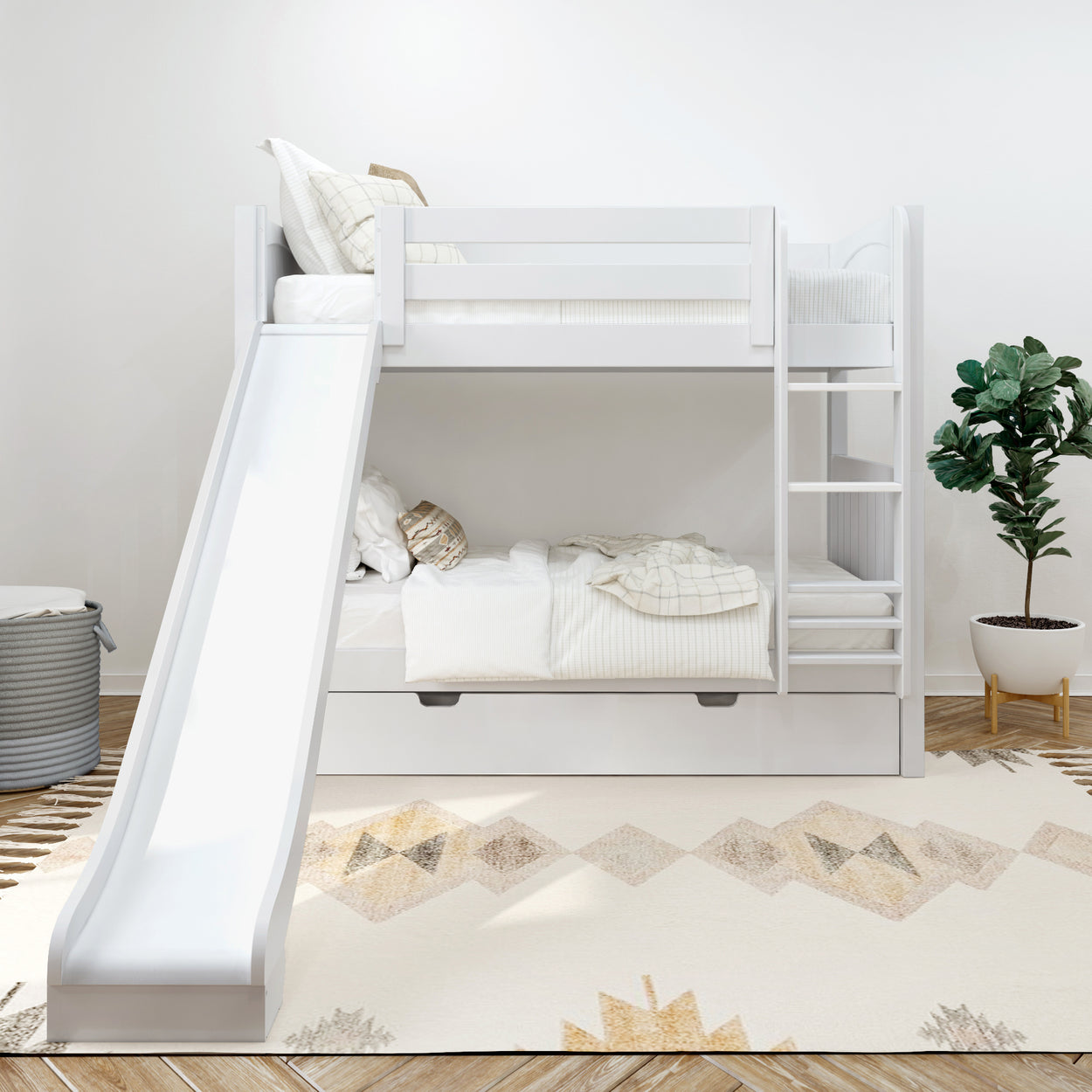 White children's bunk bed with slide and ladder, styled in a modern bedroom with soft geometric rug and indoor plant.