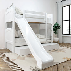 White kids' bunk bed with slide in a bright, modern bedroom featuring cozy bedding, a rug, and a potted plant.