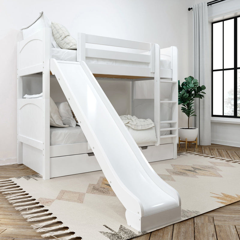 White wooden twin-over-twin bunk bed with slide, ladder and under-bed storage drawers in bright modern kids' bedroom with rug and potted plant