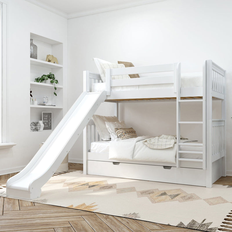 White wooden twin-over-twin bunk bed with slide and under-trundle drawer in bright modern kids bedroom with ladder, neutral bedding, built-in shelves and geometric rug