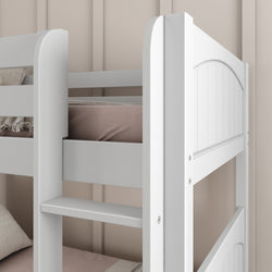 White wooden bunk bed with light brown bedding in a modern, minimalist bedroom.