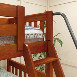 Wooden bunk bed with built-in ladder and decorative bedding in a cozy bedroom setting.