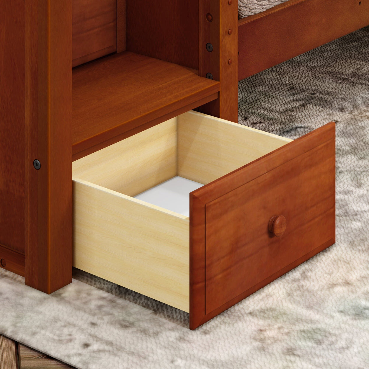 Wooden dresser with open wooden drawer on carpeted floor.