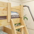 Close-up of a natural pine wooden bunk bed ladder and safety rail with blue-striped quilt and indoor plant in a cozy bedroom