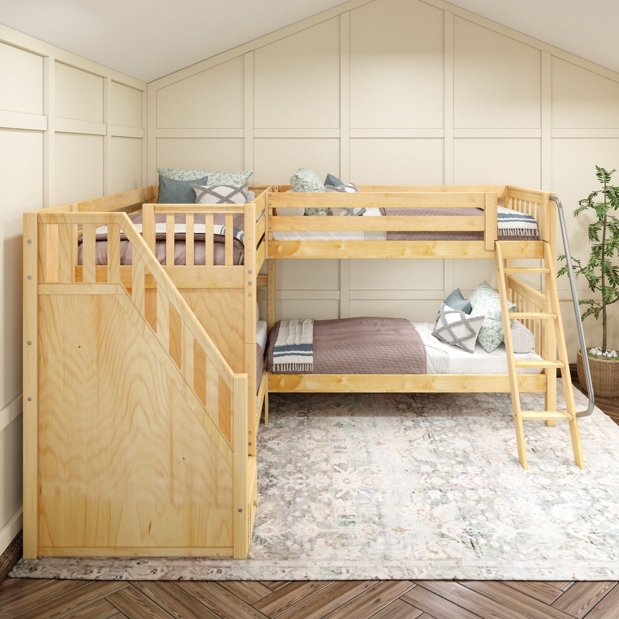 Two-level wooden bunk bed with stairs in a cozy, light-toned bedroom featuring decorative cushions and potted plant.