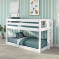 White wooden twin-over-twin bunk bed with teal bedding in a modern kids' room with green striped wallpaper and framed insect artwork