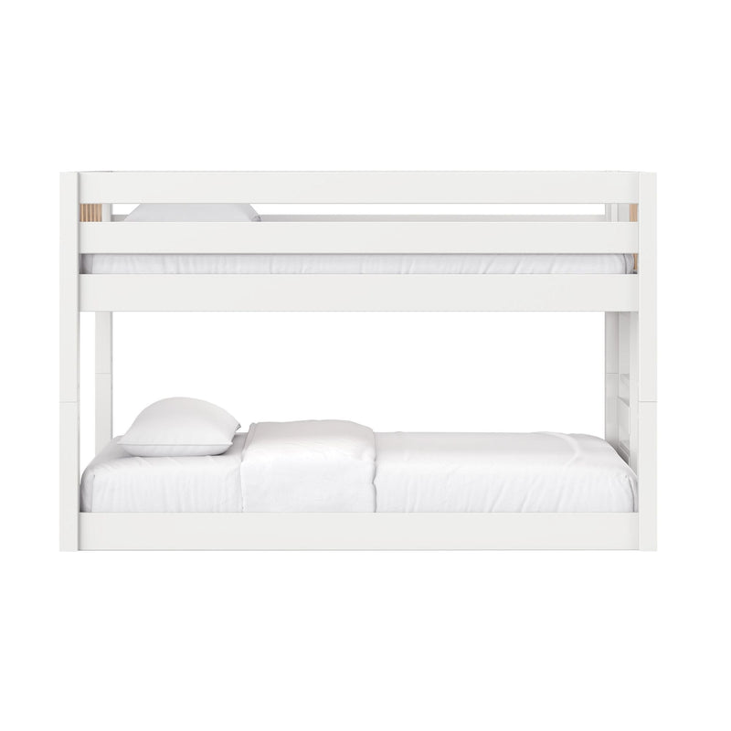 White wooden twin-over-full bunk bed with safety rails and white bedding in a modern kids' bedroom