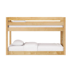 Solid natural wood bunk bed frame with slatted safety rail and white bedding for kids' bedroom