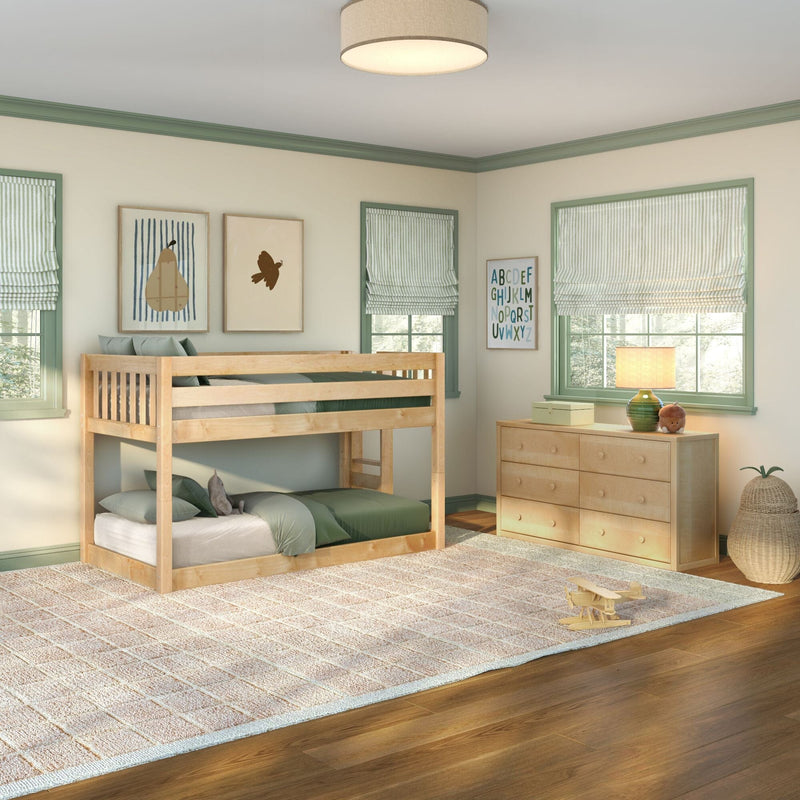 Bright kids' bedroom with natural wood bunk bed, sage green trim, striped Roman shades, dresser, alphabet wall art and bedside lamp