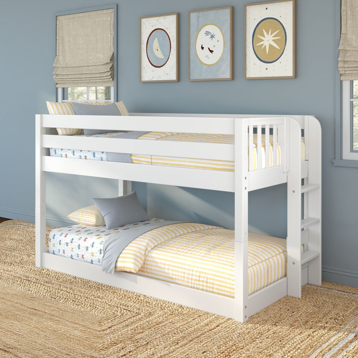 White wooden twin-over-twin bunk bed with ladder in coastal kids bedroom — blue walls, yellow striped bedding and jute rug.