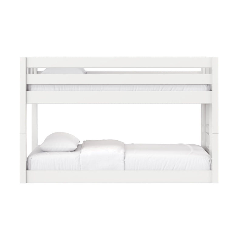 White wooden bunk bed with guardrails and ladder, white bedding in modern kids' bedroom