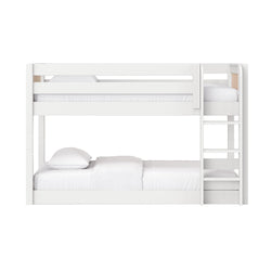 Modern white wooden twin-over-full bunk bed with ladder, natural wood accents and white bedding
