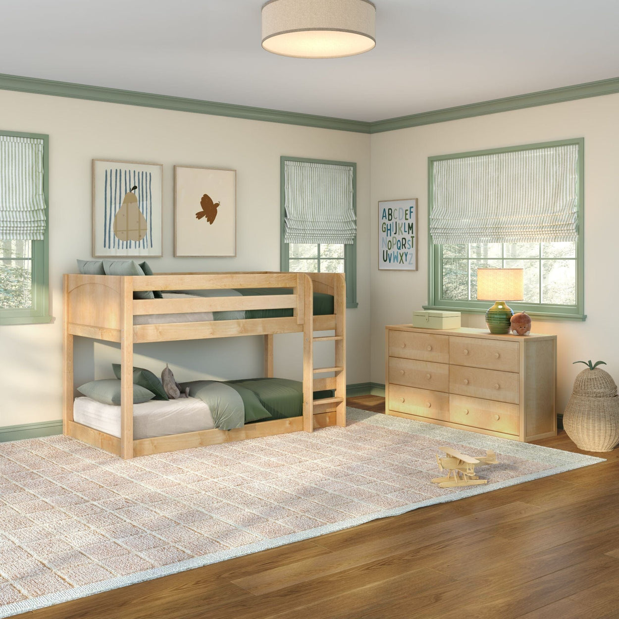 Kids bedroom with natural wood bunk bed, green bedding and trim, matching dresser, neutral area rug, window roman shades and toy airplane