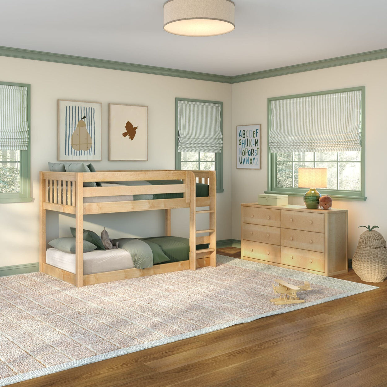 Light-filled kids bedroom with natural wood bunk bed and matching dresser, green bedding and trim, striped Roman shades, neutral area rug, and wooden toy plane