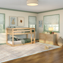 Light-filled kids bedroom with natural wood bunk bed and matching dresser, green bedding and trim, striped Roman shades, neutral area rug, and wooden toy plane