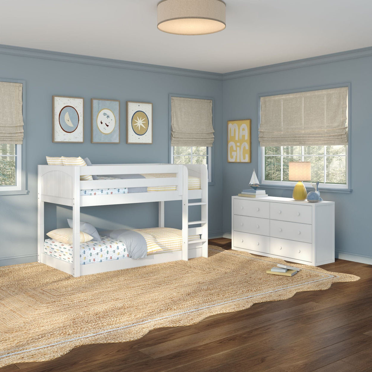 White twin-over-twin bunk bed in blue children's bedroom with white dresser, jute rug, hardwood floors, roman shades and wall art