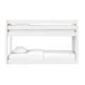 Modern white painted-wood bunk bed with upper safety guardrail and white bedding, minimalist children's bedroom furniture
