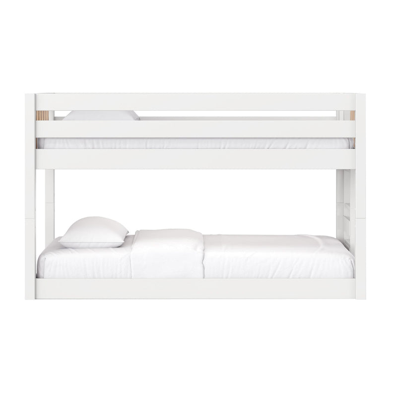 Modern white painted-wood bunk bed with upper safety guardrail and white bedding, minimalist children's bedroom furniture