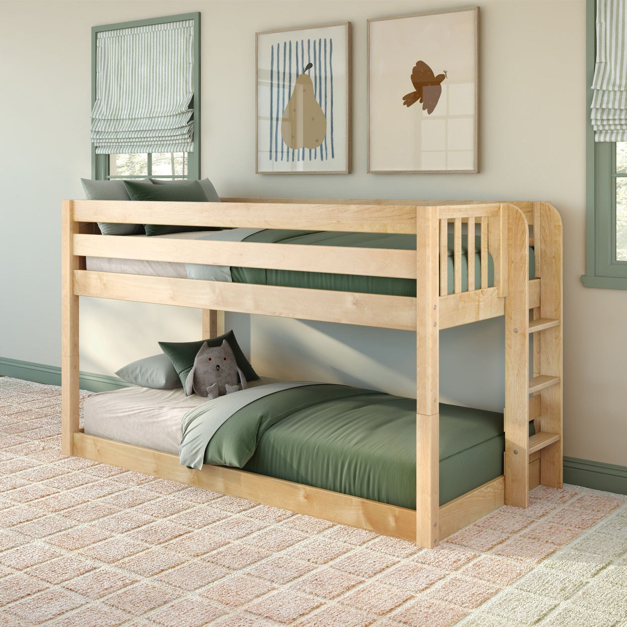 Twin-over-twin natural wood bunk bed in kids' bedroom with green bedding, ladder and safety rails, plush toy and framed wall art
