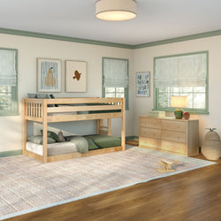 Kids bedroom with natural wood bunk bed, green bedding, wooden dresser, alphabet wall art, roman shades and area rug on hardwood floor