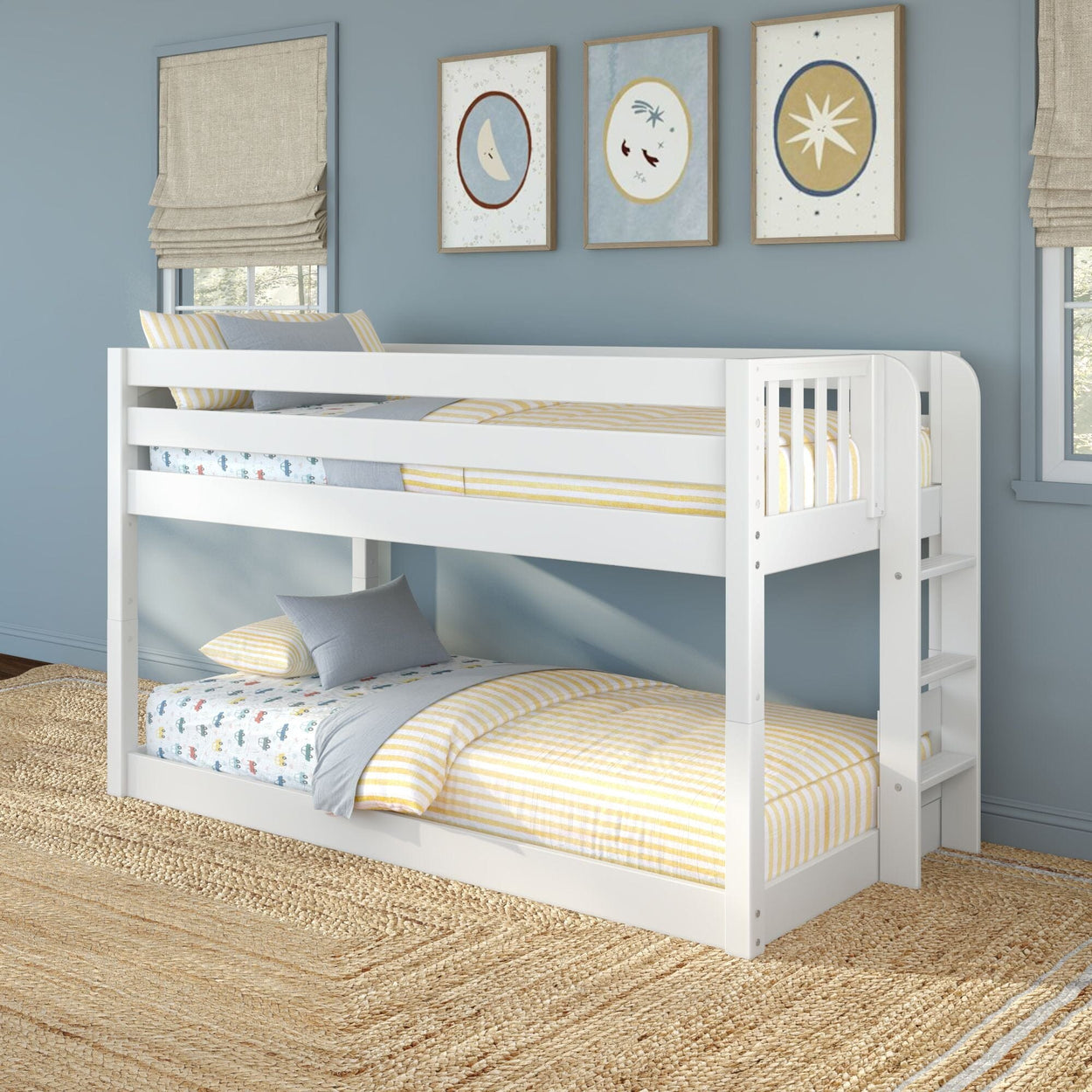 White twin-over-twin bunk bed with ladder in a children's bedroom, blue walls, yellow striped bedding and nautical-themed wall art