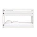White wooden bunk bed with safety guardrails and white mattresses and pillows, modern loft-style design for kids' bedroom