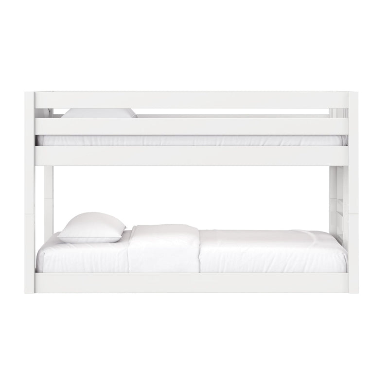 White wooden bunk bed with safety guardrails and white mattresses and pillows, modern loft-style design for kids' bedroom